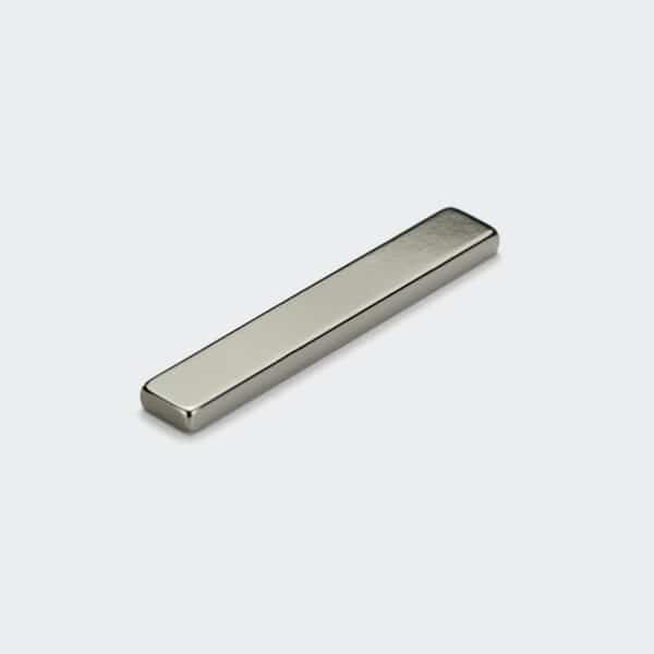 Long and thin bar-shaped rare earth magnets with silver nickel plating, laid flat on white desktop.