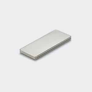 Two stacked flat rectangular NdFeB magnets with silver nickel plating surface treatment, laid on a white desktop.