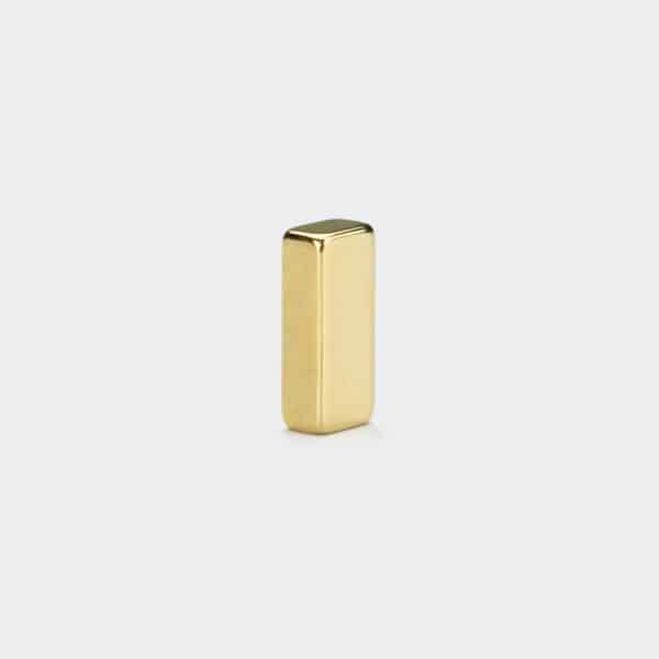 A shiny small neodymium block magnets with gold plating surface, vertically standing on a white background.