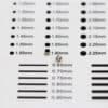 Two mini neodymium cylindrical magnets placed on a precision size estimation chart.