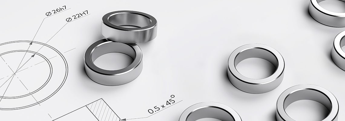 Closeup of precision-made neodymium ring magnets as per technical drawings, showcasing quality and expertise in custom magnetic solutions.