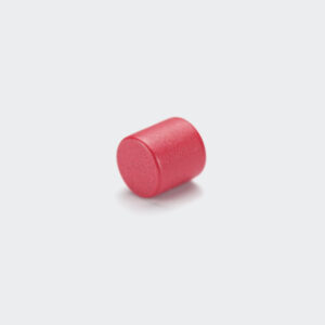 A small strong round magnet with red epoxy coating, laid on its side on a white background.