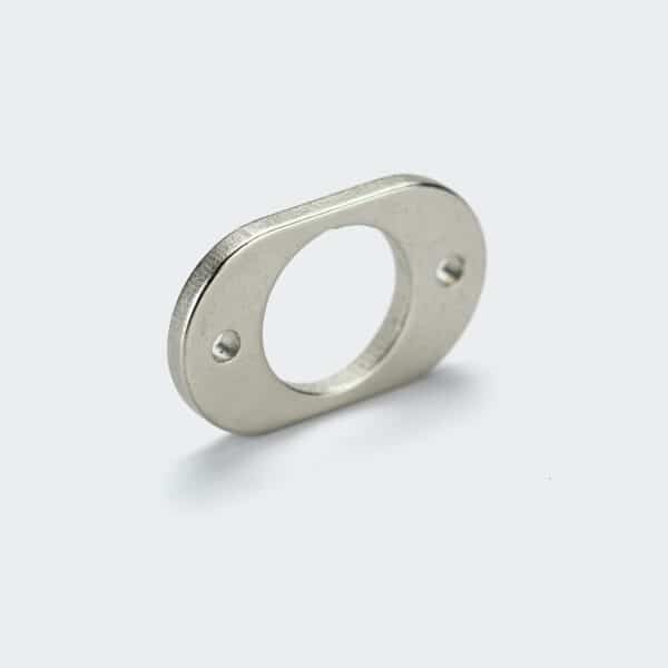 An oval rare earth magnet with a center hole and two small mounting holes, rounded corners and silver nickel plating.