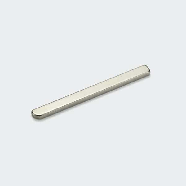 A small long thin strong plate magnet with a chamfered corner, silver nickel plating surface treatment.