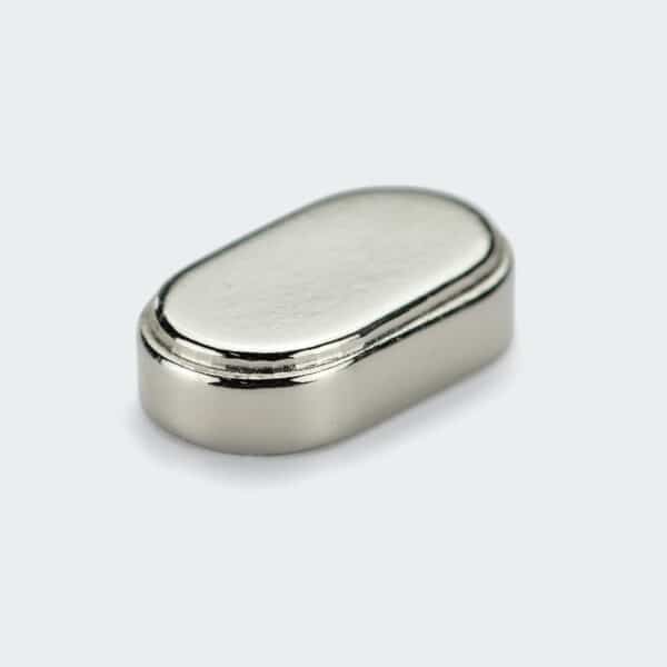 A rectangular NdFeB magnet with rounded corners, a tapered top, and with silver nickel plated surface finish.