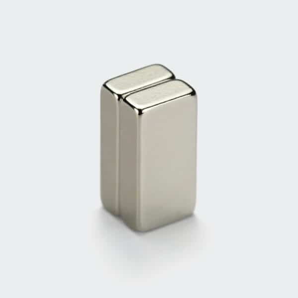 Two shiny nickel plated NdFeB block magnets made from material grade H, vertically stacked together.