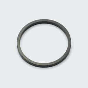 A black sintered neodymium ring magnet with multipole magnetization by its outer diameter on a white desk.