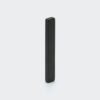 A black epoxy coated long thin neodymium bar magnet made from material grade H 120°C vertically standing on a desk