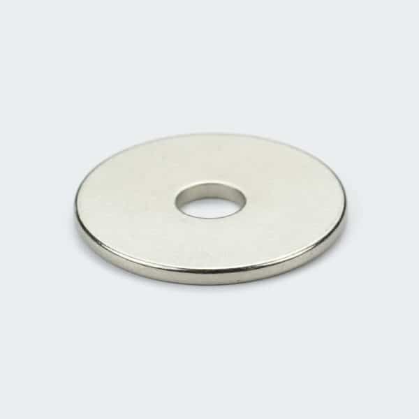 A smooth nickel plated NdFeB disc magnet with a clearance hole in the center for positioning